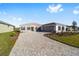 Single-story home with paver driveway and two-car garage at 9739 Sw 79Th Lane Rd, Ocala, FL 34481