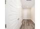 Bright hallway with wood-look floors and two white doors at 9739 Sw 79Th Lane Rd, Ocala, FL 34481