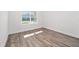 Bright bedroom with wood-look flooring and large window at 9757 Sw 79Th Lane Rd, Ocala, FL 34481