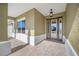 Covered front porch with paver flooring and a modern glass front door at 9757 Sw 79Th Lane Rd, Ocala, FL 34481