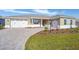 Landscaped front yard with paver driveway and two-car garage at 9757 Sw 79Th Lane Rd, Ocala, FL 34481