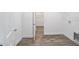 Laundry room with wood-look floors and built-in shelving at 9757 Sw 79Th Lane Rd, Ocala, FL 34481
