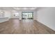 Spacious living room with wood-look floors and access to the backyard at 9757 Sw 79Th Lane Rd, Ocala, FL 34481