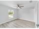 Spacious bedroom with ceiling fan and large window at 10177 Sw 137Th Ct, Dunnellon, FL 34432