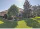 Home's backyard features a well-manicured lawn and mature trees at 12152 Se 91St Ave, Summerfield, FL 34491