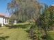 Expansive backyard with a large tree and flowerbed at 12152 Se 91St Ave, Summerfield, FL 34491