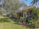 Backyard with lush landscaping and a large tree at 12152 Se 91St Ave, Summerfield, FL 34491