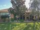 Landscaped backyard with a large tree and screened enclosure at 12152 Se 91St Ave, Summerfield, FL 34491