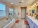 Elegant bathroom with double vanity, soaking tub, and walk-in shower at 12152 Se 91St Ave, Summerfield, FL 34491