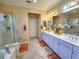 Spa-like bathroom featuring a double vanity and a large shower at 12152 Se 91St Ave, Summerfield, FL 34491