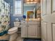 Updated bathroom with white vanity and floral shower curtain at 12152 Se 91St Ave, Summerfield, FL 34491