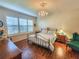 Spacious Primary bedroom with a metal bed frame, hardwood floors, and chandelier at 12152 Se 91St Ave, Summerfield, FL 34491