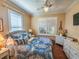 Guest bedroom with a queen bed, white dresser and window shutters at 12152 Se 91St Ave, Summerfield, FL 34491