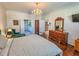 Primary bedroom with a metal bed frame, hardwood floors, and access to bathroom at 12152 Se 91St Ave, Summerfield, FL 34491