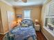 Cozy guest bedroom with a full-size bed, nightstands and window shutters at 12152 Se 91St Ave, Summerfield, FL 34491