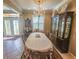 Elegant dining room featuring a large table, chandelier, and built-in hutch at 12152 Se 91St Ave, Summerfield, FL 34491