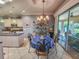 Bright dining room with chandelier and view to the kitchen at 12152 Se 91St Ave, Summerfield, FL 34491
