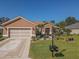 Beautiful one-story home with a two-car garage and landscaped front yard at 12152 Se 91St Ave, Summerfield, FL 34491