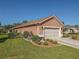 Two-car garage with decorative driveway and landscaping at 12152 Se 91St Ave, Summerfield, FL 34491