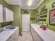 Bright laundry room with washer, dryer, and ample counter space at 12152 Se 91St Ave, Summerfield, FL 34491