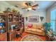 Home office with built-in wooden shelving, a tan couch, and hardwood floors at 12152 Se 91St Ave, Summerfield, FL 34491
