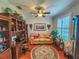 Home office with built-in wooden shelving, a tan couch, and hardwood floors at 12152 Se 91St Ave, Summerfield, FL 34491