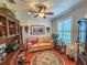 Home office with built-in wooden shelving, a tan couch, and hardwood floors at 12152 Se 91St Ave, Summerfield, FL 34491