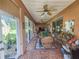 Bright sunroom with wicker furniture and access to the backyard at 12152 Se 91St Ave, Summerfield, FL 34491