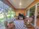 Bright sunroom with wicker furniture and access to the backyard at 12152 Se 91St Ave, Summerfield, FL 34491