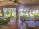 Bright sunroom with wicker furniture and access to the backyard at 12152 Se 91St Ave, Summerfield, FL 34491