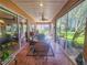 Bright and airy sunroom with wicker furniture and large windows at 12152 Se 91St Ave, Summerfield, FL 34491