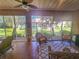 Bright sunroom with wicker furniture and access to the backyard at 12152 Se 91St Ave, Summerfield, FL 34491