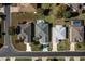 Aerial view of three homes with a pool in a residential area at 15750 Sw 11Th Court Rd, Ocala, FL 34473