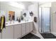 Double vanity bathroom with a large mirror and a walk-in shower at 15750 Sw 11Th Court Rd, Ocala, FL 34473
