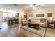 Living room with hardwood floors, comfortable seating, and kitchen views at 15750 Sw 11Th Court Rd, Ocala, FL 34473