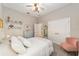 Bedroom with white bedding, pale blue dresser, and pink armchair at 363 Sw 48Th Ln, Ocala, FL 34471