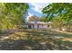 Home's back exterior with patio and fenced yard at 3645 Ne 18Th Ct, Ocala, FL 34479