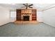 Cozy living room with a brick fireplace, built-in shelving, and ample natural light at 39 Emerald Dr, Ocala, FL 34472