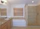 Bathroom with granite vanity, soaking tub and shower at 4085 Sw 49Th Ave, Ocala, FL 34474
