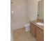 Clean bathroom with tub, granite countertop, and wood cabinets at 4085 Sw 49Th Ave, Ocala, FL 34474