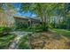 Landscaped backyard oasis with stone pathway and lush greenery at 5004 Se 5Th Ave, Ocala, FL 34480
