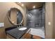 Updated bathroom features a glass shower, stone tile and a modern vanity at 5004 Se 5Th Ave, Ocala, FL 34480