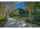 Long driveway with landscaping and a gate leading to the home at 5004 Se 5Th Ave, Ocala, FL 34480