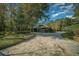 House exterior with paved driveway, landscaping, and a stone retaining wall at 5004 Se 5Th Ave, Ocala, FL 34480