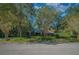Spacious home with a large front yard and mature trees at 5004 Se 5Th Ave, Ocala, FL 34480