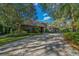 Home's exterior features a paver driveway and meticulously maintained landscaping at 5004 Se 5Th Ave, Ocala, FL 34480