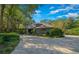 Beautiful home with paver driveway, lush landscaping, and stone accents at 5004 Se 5Th Ave, Ocala, FL 34480