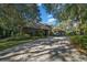 Home's exterior features a paved driveway and lush landscaping at 5004 Se 5Th Ave, Ocala, FL 34480