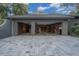 Three-car garage with ample storage space and epoxy flooring at 5004 Se 5Th Ave, Ocala, FL 34480