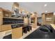 Open kitchen boasts a large island with black countertops and stainless steel appliances at 5004 Se 5Th Ave, Ocala, FL 34480
